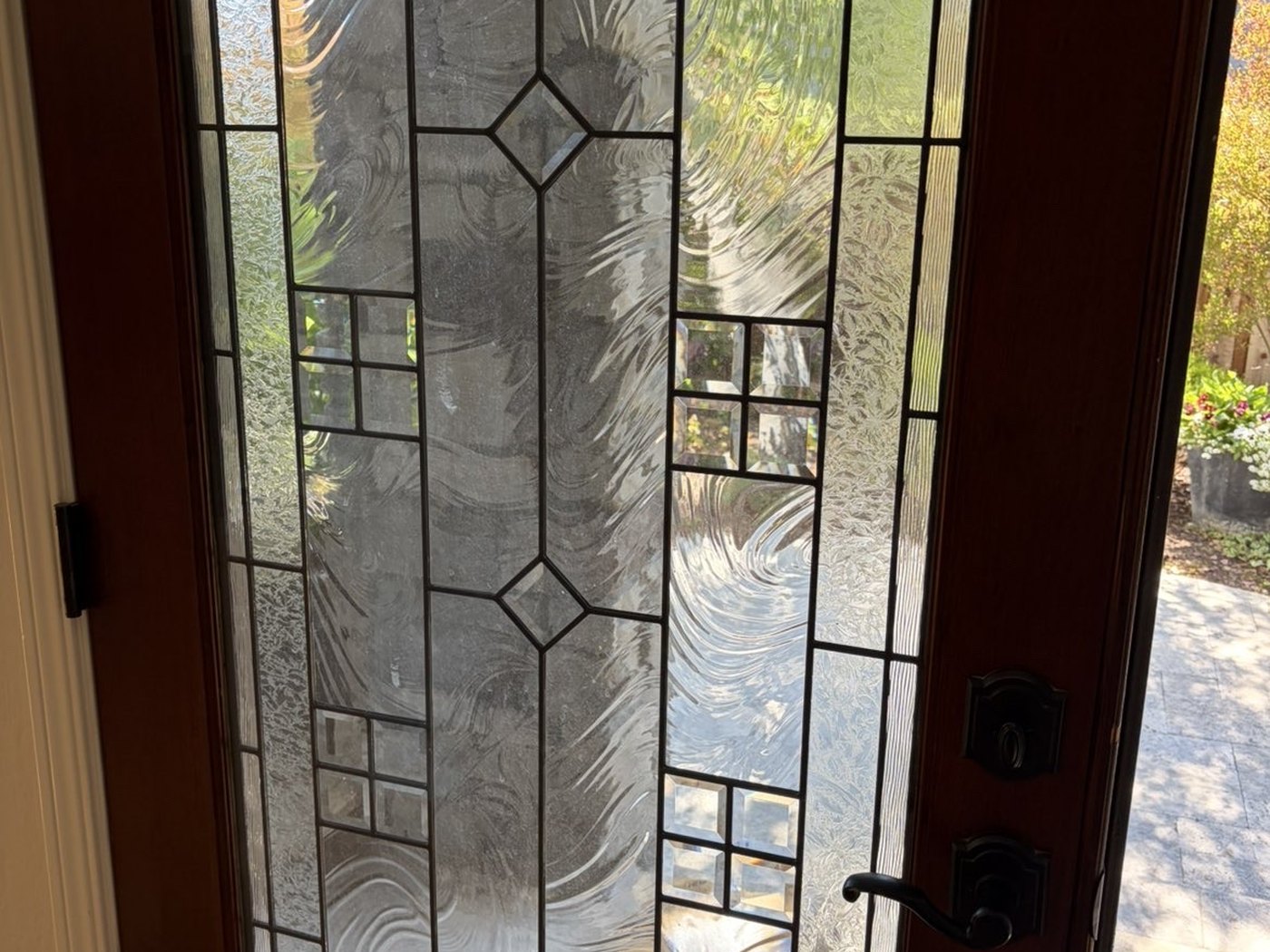 Leaded-glass entry door before cleaning, from inside