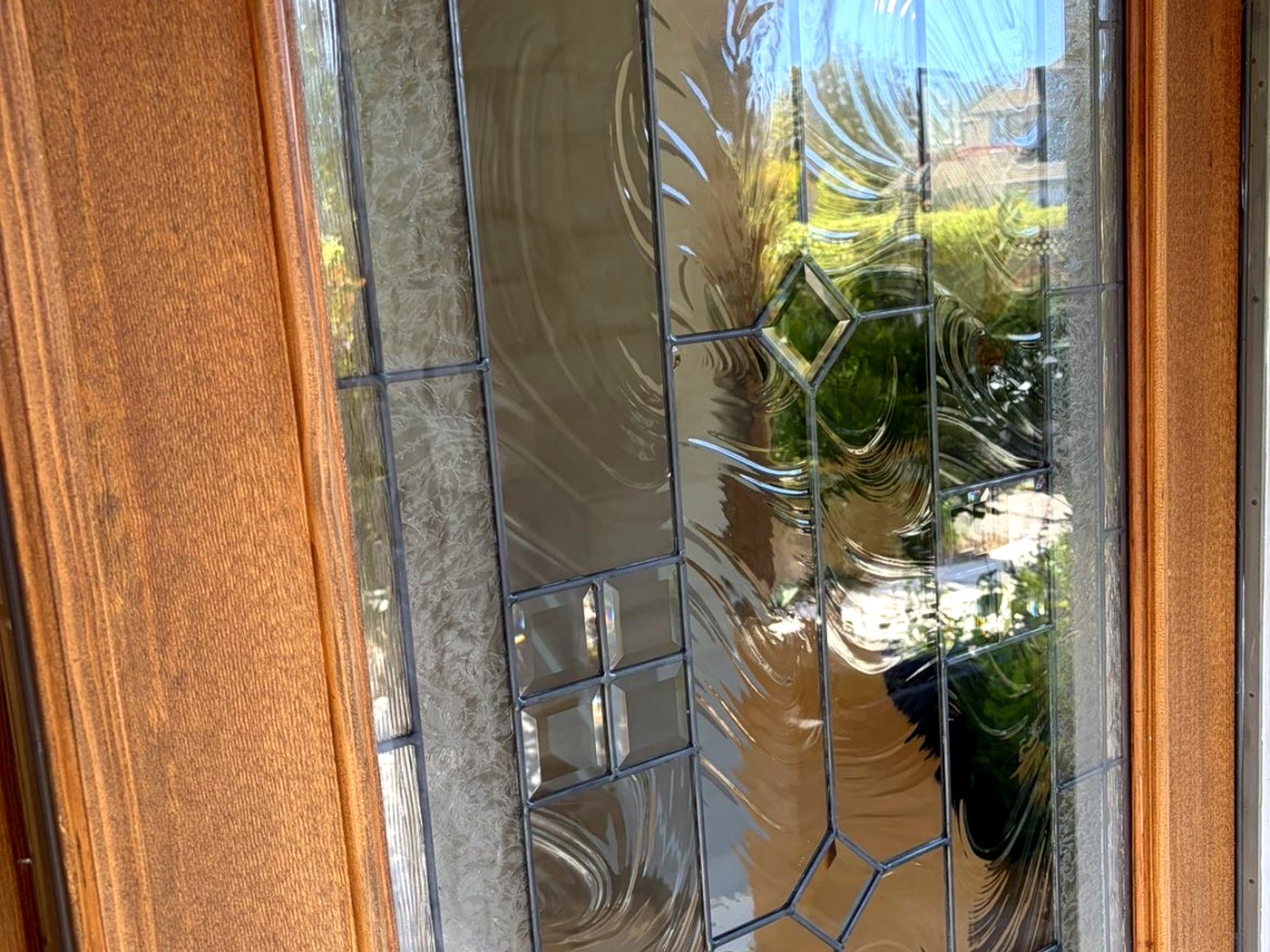 Leaded-glass entry door after cleaning, from outside